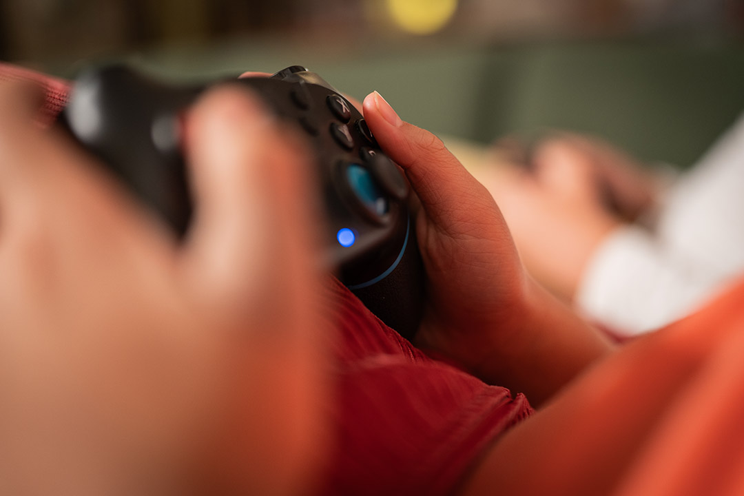 Close up of hands on a game controller